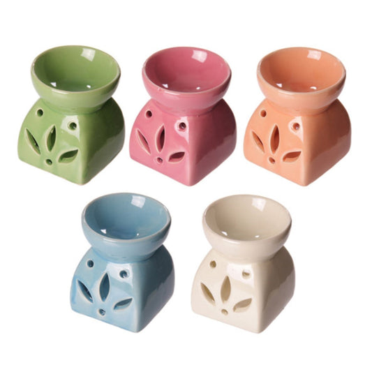 Buy Modern Cermaic Oil Burner. Wax Melts, Essential Oils, Water. - This ceramic oil burner features a cut-out leaf design that allows a vivid, beautiful flame to dance through the openings as it warms your space. Use it with oil, water or wax melts - simply add your fuel of choice and let the burner do the work of creating an aromatic atmosphere. A welcoming accent for living rooms, bedrooms or offices, this oil burner brings the soothing scents of nature indoors. at Sacred Remedy Online