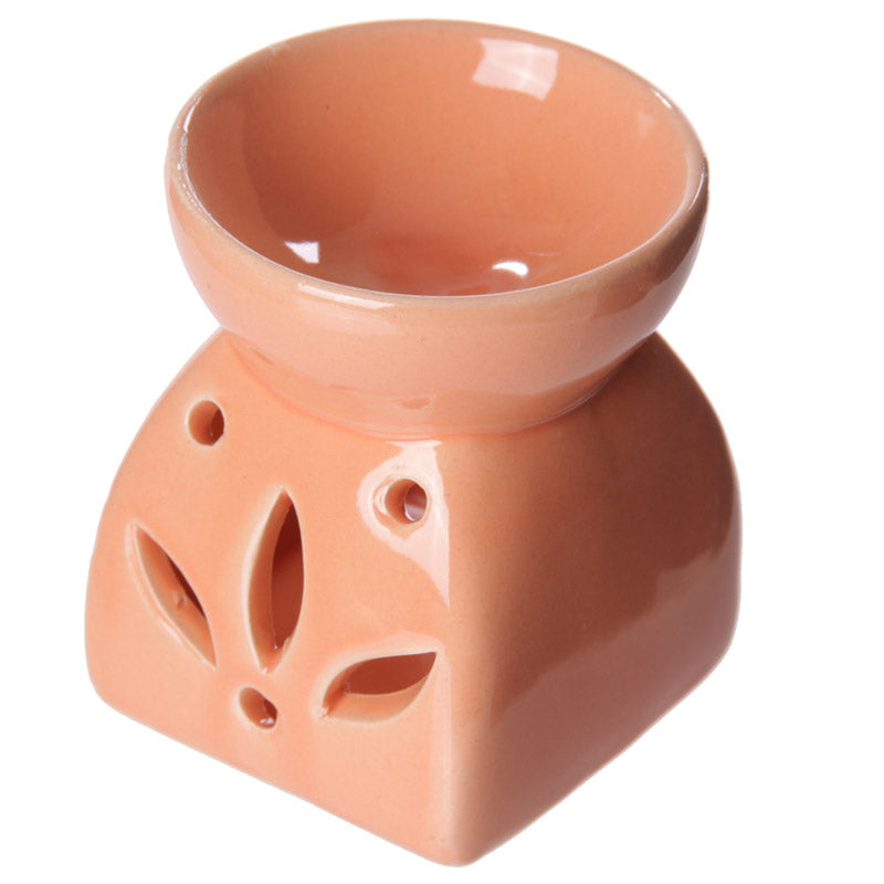 Buy Modern Cermaic Oil Burner. Wax Melts, Essential Oils, Water. - This ceramic oil burner features a cut-out leaf design that allows a vivid, beautiful flame to dance through the openings as it warms your space. Use it with oil, water or wax melts - simply add your fuel of choice and let the burner do the work of creating an aromatic atmosphere. A welcoming accent for living rooms, bedrooms or offices, this oil burner brings the soothing scents of nature indoors. at Sacred Remedy Online